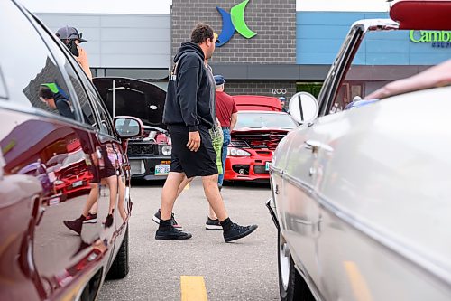 Mike Sudoma/Free Press
Attendees walk down aisles of cars at the Winnipeg Cruise Culture Sunday night
August 9, 2026