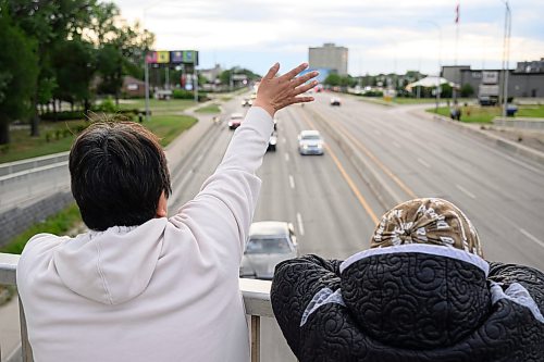 Mike Sudoma/Free Press
Friends Diane Haqpi (left) and Joan Iqqaat (right) wave at as cars cruise down Portage avenue during Sunday night cruise night
August 9, 2026