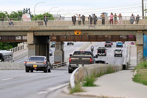 Mike Sudoma/Free Press
A Small crowd watches and waves as cars cruise down Portage avenue during Sunday night cruise night
August 9, 2026