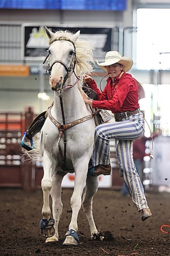 Emily Rosvold of Ethelbert slides off her horse while competing in the goat-tying event. (Tim Smith/The Brandon Sun)