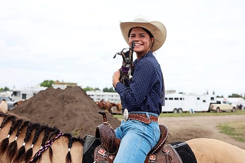 13082026
Ruby Oxtoby of Esterhazy, Saskatchewan holds her pygmy goat Midge while atop her quarter-horse Chickadee at the high school rodeo on the opening day of the 2026 Virden Indoor Rodeo and Wild West Daze on Thursday. The annual Rodeo and Wild West Daze runs until Sunday with a variety of events including a parade, a demolition derby, nightly rodeo performances and other events. (Tim Smith/The Brandon Sun)