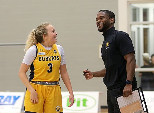 Brandon University guard Piper Ingalls and coach Ilarion Bonhomme share a laugh late in the fourth quarter of their Canada West women's basketball season opener on Friday. (Thomas Friesen/The Brandon Sun)