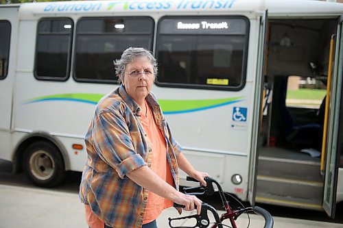 Caroline Fischer stands in front of the Access Transit bus after being dropped off at the Brandon Regional Health Centre for dialysis treatment on Wednesday. (Tim Smith/The Brandon Sun)