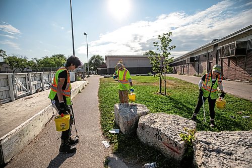 MIKAELA MACKENZIE / FREE PRESS
	
City crew members Alex Cloney (left), Kyle Bergantim and Tee Silver clean up needles and other hazardous materials at Freight House park on Thursday, Aug. 13, 2026.

For Malak story.
Free Press 2026