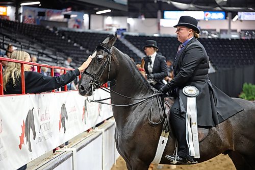 14082026
Sara Embury with Milligan Training pets her horse KT Cloudstorm, ridden by Erica Milligan, after Milligan and KT Cloudstorm competed in the half Arabian country english pleasure ladies and gentlemen to ride category at the Canada's National Arabian Championship at the Keystone Centre on Friday. The Arabian show wraps up today. (Tim Smith/The Brandon Sun)
