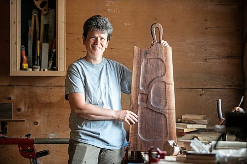 MIKAELA MACKENZIE / FREE PRESS
Woodworker Marina Bulan with one of her charcuterie boards in her workshop on Monday, Aug. 17, 2026. She started her business, Cedarella, after taking a cabinetry course at Red River.
For Dave Sanderson story.
Free Press 2026