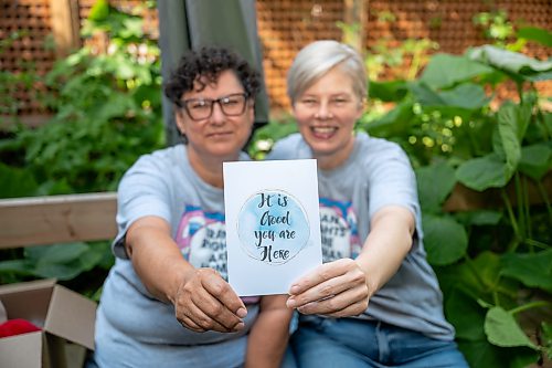 ROBERT LEE / FREE PRESS
Kalyn Falk, right, and project partner Lindsay Unger display a card that is shared with recipients of the care packages in Winnipeg on Monday, August 17, 2026. The pair help lead the TDOR Care Package Project, launched in 2020 to honour Trans Day of Remembrance by preparing about 50 care packages so trans and non-binary community members feel valued, seen and cared for. This year, the project is partnering with Resource Assistance for Youth, which will accept donations and issue charitable tax receipts ahead of the Nov. 20 day of remembrance.