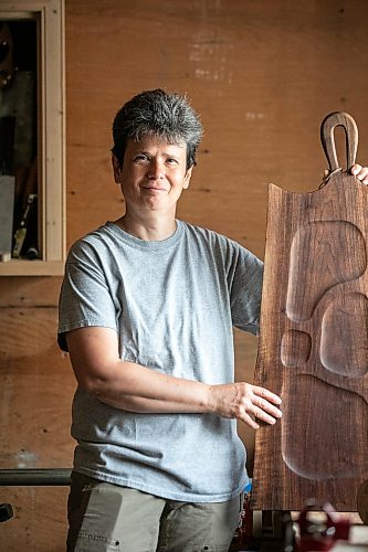 MIKAELA MACKENZIE / FREE PRESS
Woodworker Marina Bulan with one of her charcuterie boards in her workshop on Monday, Aug. 17, 2026. She started her business, Cedarella, after taking a cabinetry course at Red River.
For Dave Sanderson story.
Free Press 2026