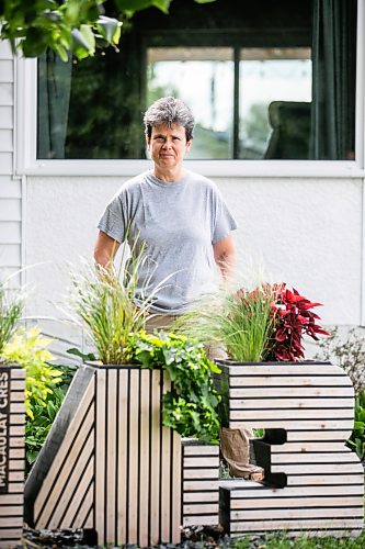 MIKAELA MACKENZIE / FREE PRESS
Woodworker Marina Bulan with one of her signature street number planters on Monday, Aug. 17, 2026. She started her business, Cedarella, after taking a cabinetry course at Red River.
For Dave Sanderson story.
Free Press 2026