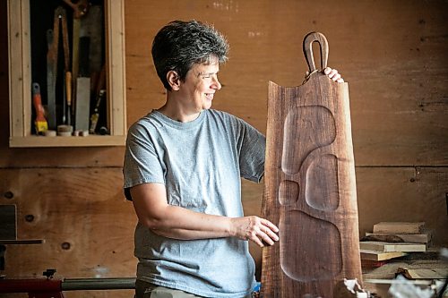 MIKAELA MACKENZIE / FREE PRESS
Woodworker Marina Bulan with one of her charcuterie boards in her workshop on Monday, Aug. 17, 2026. She started her business, Cedarella, after taking a cabinetry course at Red River.
For Dave Sanderson story.
Free Press 2026