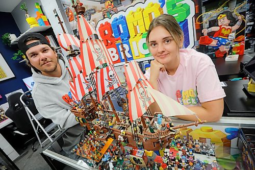 JOHN WOODS / FREE PRESS
Madison Froome and Ashton Romaniuk are photographed with a Lego MOC (My Own Creation) in their new Lego store Romo’s Bricks Tuesday, July 21, 2026. A friend of theirs created this pirate ship from miscellaneous Lego pieces from other kits.
reporter: aaron