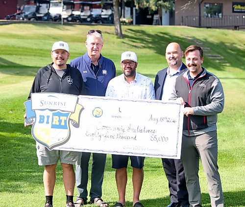 Brandon University's Tyler Crayston (centre), flanked by, from left to right, BU's Chris Falkevitch, athletic director Russ Paddock, Sunrise Credit Union chief operating officer Tony Keown and Brandon branch manager Derian Penziwol, shows off an $85,000 cheque from the BIRT Cup. (Rowan McCarthy/Brandon Sun)
