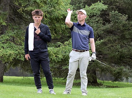 Joel Matthews, right, talks through a shot with son and caddie, Kolton, during the first round of the Tamarack golf tournament men's championship flight matches at Clear Lake Golf Course on Tuesday. (Thomas Friesen/The Brandon Sun)