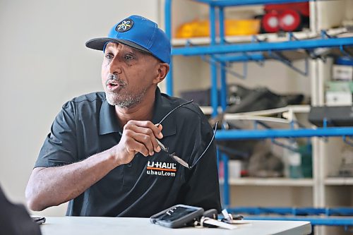 ABC Auto Service and Salvage owner Sam Mulaw gestures with his glasses in hand during an interview with Brandon Sun business reporter Abiola Odutola on Tuesday afternoon. (Matt Goerzen/The Brandon Sun)