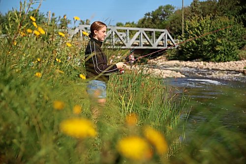 18082026
Teagan Helbig fishes from the bank of Plum Creek in Souris, Manitoba on Tuesday while visiting the westman community with family and friends.
(Tim Smith/The Brandon Sun)