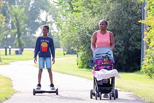 18082026
Titilope Cecelia Adeleke enjoys a walk at Kin Park with her children Jordan and Joan on a sunny Tuesday morning.
(Tim Smith/The Brandon Sun)