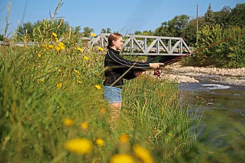 18082026
Teagan Helbig fishes from the bank of Plum Creek in Souris, Manitoba on Tuesday while visiting the westman community with family and friends.
(Tim Smith/The Brandon Sun)