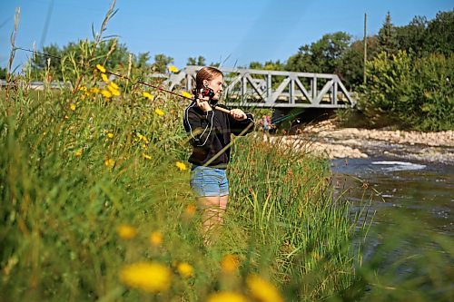 18082026
Teagan Helbig fishes from the bank of Plum Creek in Souris, Manitoba on Tuesday while visiting the westman community with family and friends.
(Tim Smith/The Brandon Sun)