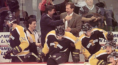 Mark Johnston (in the blue suit) hugs head coach Bobby Lowes after a series-clinching win in the playoffs. Johnston, who also served as an assistant coach, is being honoured for his work as a scout when he is inducted into the Professional Hockey Scouts Foundation’s Wall of Honour on Aug. 28 in Okotoks, Alta. (Brandon Sun file)
