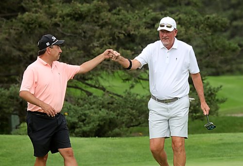 Kurt Martin, right, fist bumps Nolan Tutkaluk after halving a hole during their Tamarack golf tournament quarterfinal match on Thursday. Martin won 3 and 1. (Thomas Friesen/The Brandon Sun)