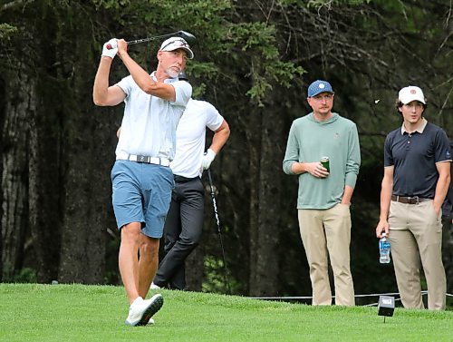 Jason Thorpe hits a tee shot while sons Ty, right, and Ryan watch during Tamarack golf tournament quarterfinals at Clear Lake Golf Course on Thursday. Thorpe beat defending champion Grady Chuback on the second playoff hole. (Thomas Friesen/The Brandon Sun)