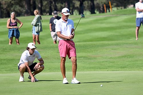 Jason Thorpe, right, and his son Ty read a green during the Tamarack final at Clear Lake Golf Course on Saturday. (Thomas Friesen/The Brandon Sun)