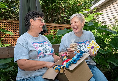 ROBERT LEE / FREE PRESS
Kalyn Falk, right, and project partner Lindsay Unger pose for a photo in Winnipeg on Monday, August 17, 2026. The pair help lead the TDOR Care Package Project, launched in 2020 to honour Trans Day of Remembrance by preparing about 50 care packages so trans and non-binary community members feel valued, seen and cared for. This year, the project is partnering with Resource Assistance for Youth, which will accept donations and issue charitable tax receipts ahead of the Nov. 20 day of remembrance.