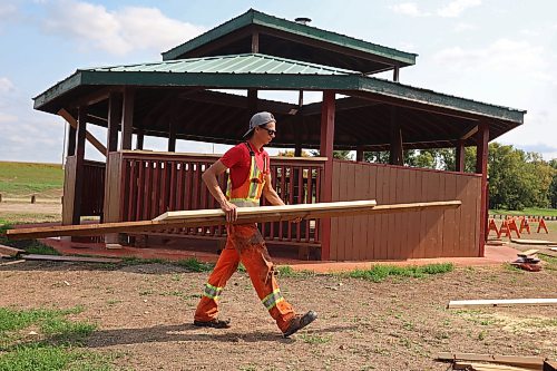 Peter Spelrem, a casual labourer with the City of Brandon, cleans up supplies while working on the repaired gazebo at Dinsdale Park on Monday. About 80 per cent of the gazebo was replaced after it was damaged during this summer's flooding. (Tim Smith/The Brandon Sun)