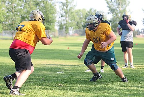 Kolby McKay (right) prepares to lay a hit on his teammate during a drill on Monday. (Rowan McCarthy/Brandon Sun)
