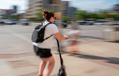 ROBERT LEE / FREE PRESS
Ashley Esquega rides her electric scooter through Winnipeg on Monday, August 24, 2026.