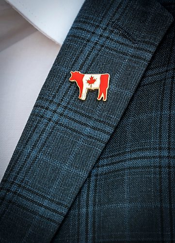 JOHN WOODS / FREE PRESS
A pin on Matthew Atkinson’s jacket who was representing Manitoba Beef Producers and Canadian Cattle Association, is seen after he met with Premier Wab Kinew and other Manitoba business leaders, unions and indigenous leaders to discuss trade relations with the United States at the Manitoba Legislature Monday, August 24, 2026. 

reporter: gabby