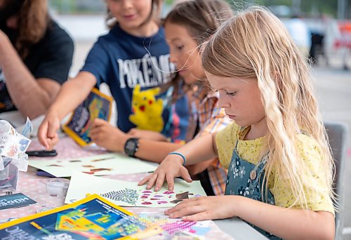 ROBERT LEE / FREE PRESS
Stella Birnie works on her collage at Scrap &amp; Yap, an arts-and-crafts collage group that has been setting up a table at the Riverview market on Monday, August 24, 2026. 