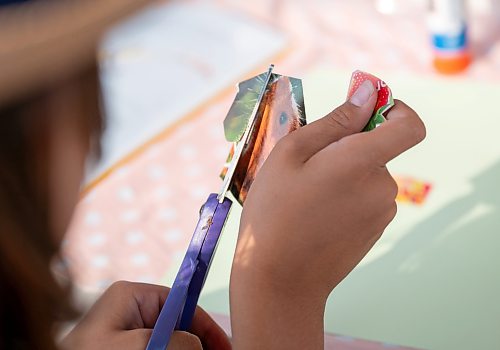 ROBERT LEE / FREE PRESS
Jack Birnie works on his collage at Scrap &amp; Yap, an arts-and-crafts collage group that has been setting up a table at the Riverview market on Monday, August 24, 2026. 