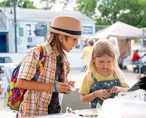 ROBERT LEE / FREE PRESS
Jack and Stella Birnie work on their collages at Scrap & Yap, an arts-and-crafts collage group that has been setting up a table at the Riverview market on Monday, August 24, 2026.