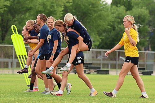 Brandon University Bobcats women’s soccer team members piggyback each other during a water break as they take part in preseason training at the university on Tuesday morning. The defending champion Bobcats start their season on Sept. 12 with their home opener.  (Tim Smith/The Brandon Sun)