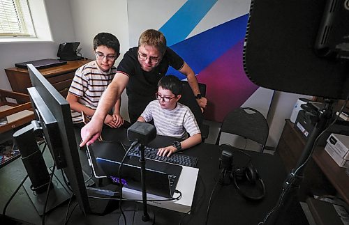 JOHN WOODS / FREE PRESS
Mohamad Alhamoud, CEO of Codora and a software engineer at Amazon, works with his sons, Joud, 9, and Khaled, 11, on his new educational platform, Codora, which provides courses in artificial intelligence, math and coding at their home in Winnipeg Tuesday, August 25, 2026. 

reporter: maggie
