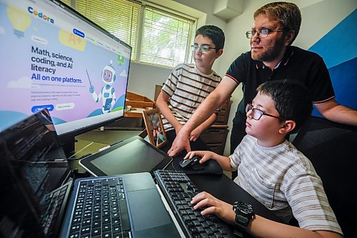 JOHN WOODS / FREE PRESS
Mohamad Alhamoud, CEO of Codora and a software engineer at Amazon, works with his sons, Joud, 9, and Khaled, 11, on his new educational platform, Codora, which provides courses in artificial intelligence, math and coding at their home in Winnipeg Tuesday, August 25, 2026. 

reporter: maggie