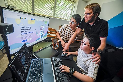 JOHN WOODS / FREE PRESS
Mohamad Alhamoud, CEO of Codora and a software engineer at Amazon, works with his sons, Joud, 9, and Khaled, 11, on his new educational platform, Codora, which provides courses in artificial intelligence, math and coding at their home in Winnipeg Tuesday, August 25, 2026. 

reporter: maggie