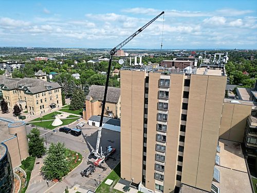 25082026
A crane is used to remove the old observatory dome for the Gulliver Astronomical Observatory from the roof of the McMaster Building at Brandon University and then to install the new dome on Tuesday. The old dome, installed in 1971 was replaced due to age and weathering. The new dome is weather-sealed and fully integrated with the telescope and automated so it can be operated remotely. The telescope was replaced in 2009. The Manitoba government provided $100,000 toward the dome replacement, alongside a $50,000 donation from the family of Brandon University astronomy professor Dr. Austin Gulliver.
(Tim Smith/The Brandon Sun)