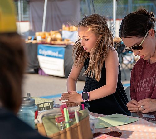 ROBERT LEE / FREE PRESS
Charlotte Silman works on her collage at Scrap & Yap, an arts-and-crafts collage group that has been setting up a table at the Riverview market on Monday, August 24, 2026.