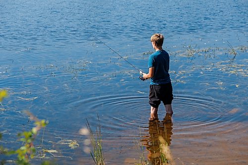 MIKE DEAL / FREE PRESS
Brothers, Cyrus Funk, 15, fishes from the shallow water of the lake at St. Malo Provincial Park.
Reporter: Melissa Martin
260821 - Friday, August 21, 2026.