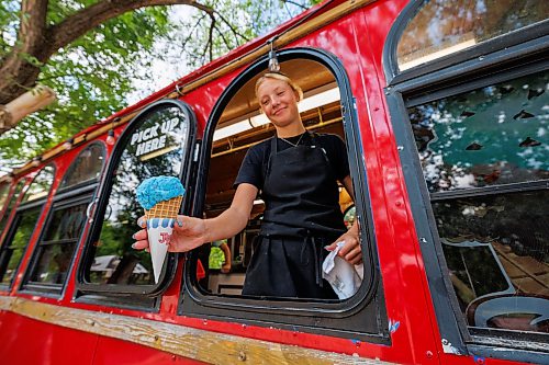 MIKE DEAL / FREE PRESS
Annika Peetsma holds out an ice cream for a customer at The Barefoot Cafe in St. Malo Provincial Park.
Reporter: Melissa Martin
260821 - Friday, August 21, 2026.