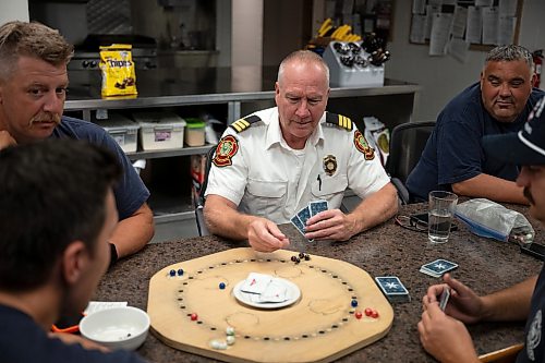 ROBERT LEE / FREE PRESS
Members of Winnipeg Fire Paramedic Service Station 1 enjoy a game of TAC between calls on Wednesday, August 19, 2026. TAC is a popular tactical board and card game from Germany.