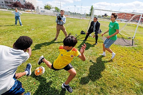 MIKE DEAL / FREE PRESS
Premier Wab Kinew plays a little bit of soccer with the kids from the BGC (Boys and Girls Club) of Winnipeg after the announcement.
Premier Wab Kinew and Education and Early Childhood Learning Minister Tracy Schmidt announces that the government is introducing a pilot program for a new health and physical education curriculum that includes an a policy making in-person physical education mandatory for all students from kindergarten to Grade 12.
The press conference held on the playground of Victor Mager School, included other stake holders who spoke; Dr. Brent Roussin, chief provincial public health officer, Jason Cline, superintendent, Rolling River School Division, Alyson Gysel, co-president, Physical Health Educators of Manitoba, and Noelle Depape, president and CEO, Boys and Girls Club Winnipeg.
Reporter: Maggie Macintosh
260827 - Thursday, August 27, 2026.