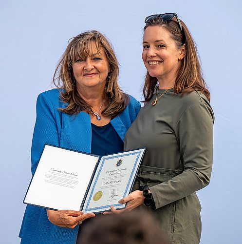 ROBERT LEE / FREE PRESS
Councillor Janice Lukes, left, presents Lea Ledohowski, Leo’s daughter and President of Canad Inns with a community service award at the unveiling of “Leo Ledohowski Way”, an honourary street naming recognizing the Canad Inns founder’s contributions to the city at Canad Inns Destination Centre Garden City in Winnipeg on Thursday, August 27, 2026. 