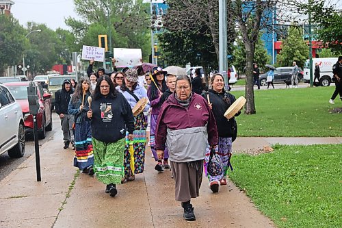 Elder Susie McPherson and a women’s drum group lead a walk to mark International Toxic Drug Poisoning Awareness Day on Monday afternoon in Brandon. (Abiola Odutola/The Brandon Sun)