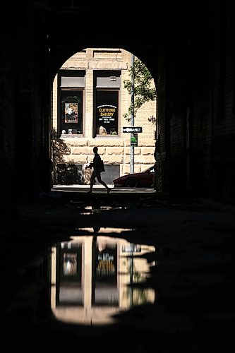 MIKAELA MACKENZIE / FREE PRESS
Puddles from recent overnight rain reflect scenes in the Exchange District on Monday, Aug. 31, 2026.
Standup.
Free Press 2026