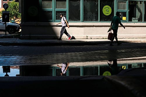 MIKAELA MACKENZIE / FREE PRESS
Puddles from recent overnight rain reflect scenes in the Exchange District on Monday, Aug. 31, 2026.
Standup.
Free Press 2026