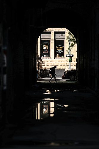 MIKAELA MACKENZIE / FREE PRESS
Puddles from recent overnight rain reflect scenes in the Exchange District on Monday, Aug. 31, 2026.
Standup.
Free Press 2026