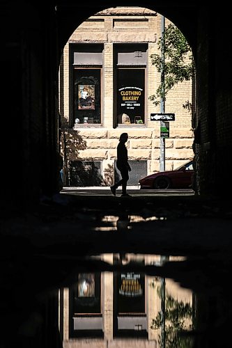 MIKAELA MACKENZIE / FREE PRESS
	
Puddles from recent overnight rain reflect scenes in the Exchange District on Monday, Aug. 31, 2026.

Standup.
Free Press 2026